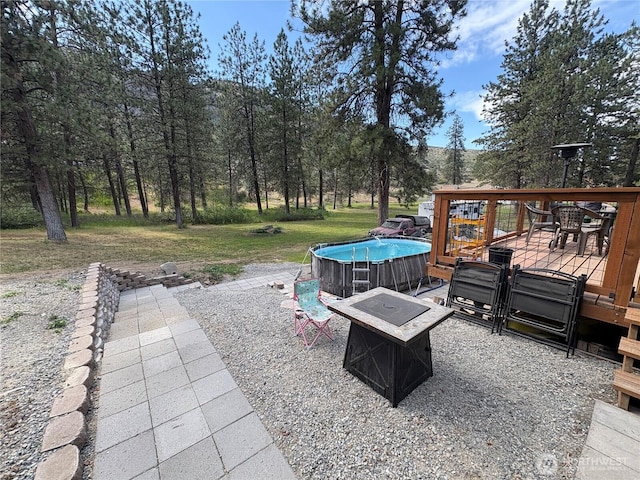 47 Pinecrest Rd, Tonasket, WA 98855 - view of patio featuring a fire pit and a deck