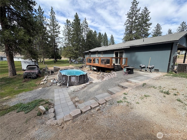 47 Pinecrest Rd, Tonasket, WA 98855 - rear view of property with a deck and an outdoor pool