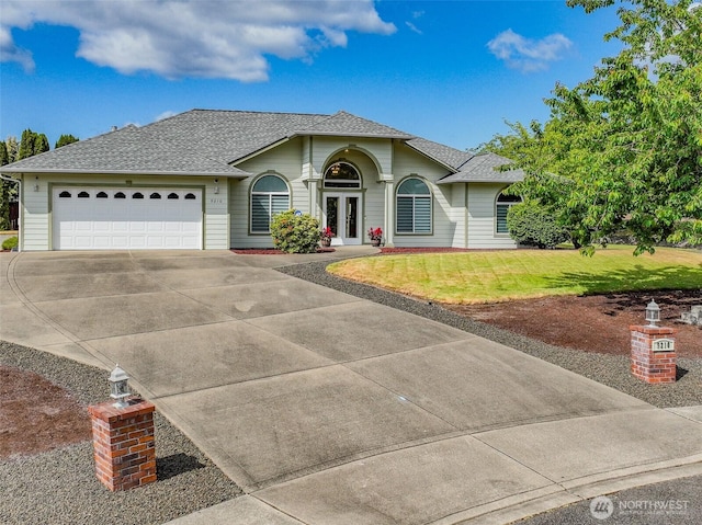 9210 Overton Ct SE, Olympia, WA 98513 - view of front of house with driveway, a garage, a front yard, roof with shingles, and french doors