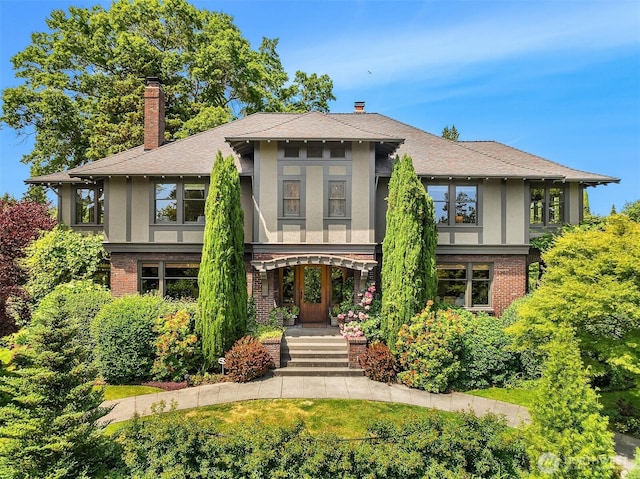 3804 S Mcclellan St, Seattle, WA 98144 - view of front of house featuring stucco siding, brick siding, a chimney, and a shingled roof