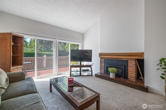 3207 SW 319th St Unit 48, Federal Way, WA 98023 - carpeted living room featuring a textured ceiling, a brick fireplace, and lofted ceiling