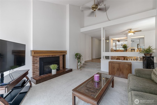 3207 SW 319th St Unit 48, Federal Way, WA 98023 - living area with ceiling fan, carpet, a towering ceiling, and a brick fireplace
