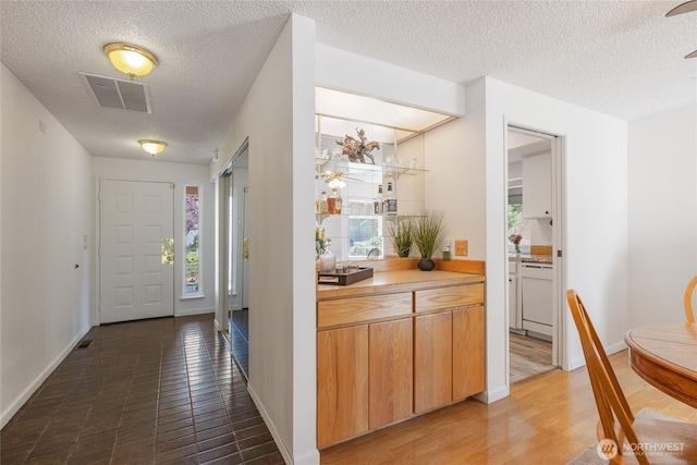 3207 SW 319th St Unit 48, Federal Way, WA 98023 - foyer featuring a textured ceiling and wood finished floors