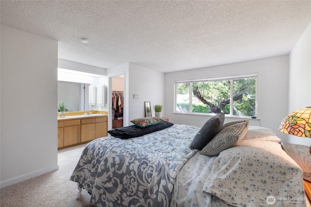 3207 SW 319th St Unit 48, Federal Way, WA 98023 - bedroom with light carpet, a spacious closet, and a textured ceiling