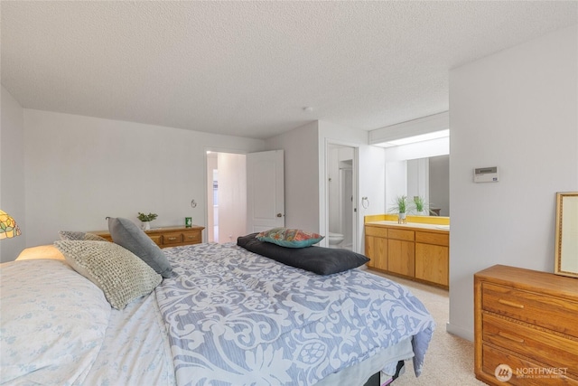 3207 SW 319th St Unit 48, Federal Way, WA 98023 - bedroom featuring a textured ceiling, ensuite bath, and light colored carpet