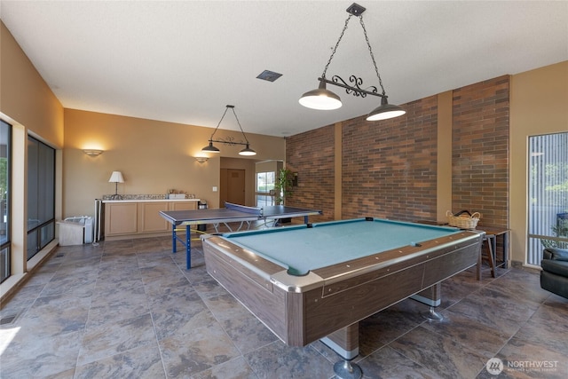 3207 SW 319th St Unit 48, Federal Way, WA 98023 - playroom with billiards table and brick wall