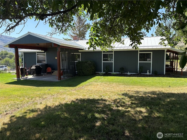 301 Main St, Riverside, WA 98849 - rear view of property with a patio, a yard, a metal roof, a standing seam roof, and a chimney
