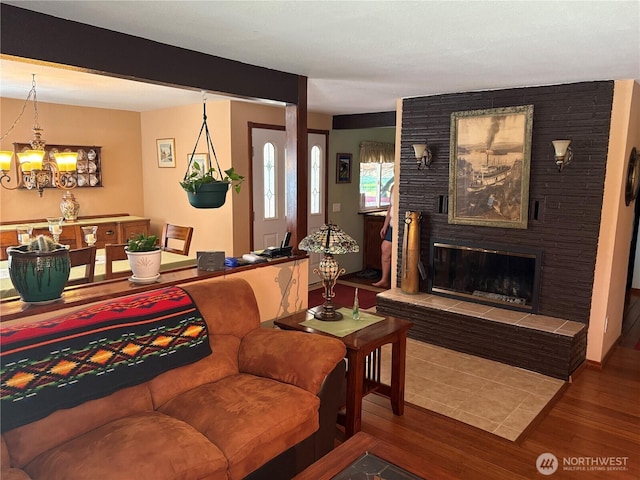 301 Main St, Riverside, WA 98849 - living area with wood finished floors, a chandelier, and a tile fireplace