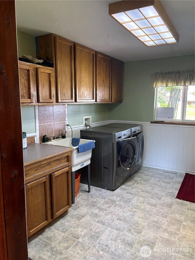 301 Main St, Riverside, WA 98849 - washroom with cabinet space, washer and dryer, and wainscoting