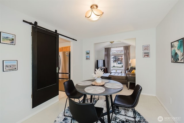 7315 E Collins Rd, Port Orchard, WA 98366 - dining room featuring a barn door and baseboards