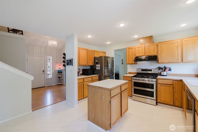 7315 E Collins Rd, Port Orchard, WA 98366 - kitchen featuring appliances with stainless steel finishes, under cabinet range hood, light floors, a kitchen island, and light countertops
