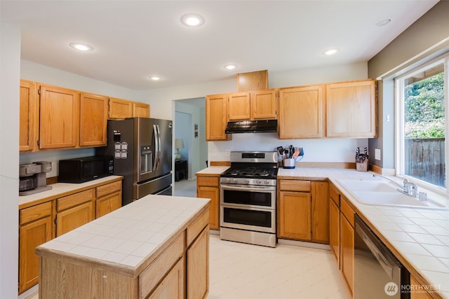 7315 E Collins Rd, Port Orchard, WA 98366 - kitchen with stainless steel appliances, tile countertops, under cabinet range hood, recessed lighting, and light brown cabinets
