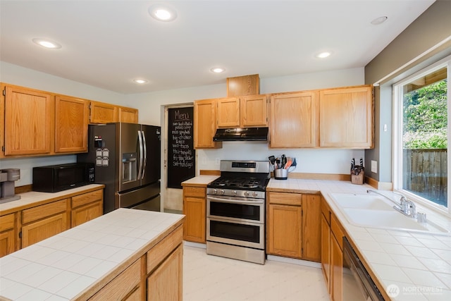 7315 E Collins Rd, Port Orchard, WA 98366 - kitchen featuring stainless steel appliances, tile counters, under cabinet range hood, recessed lighting, and light brown cabinetry