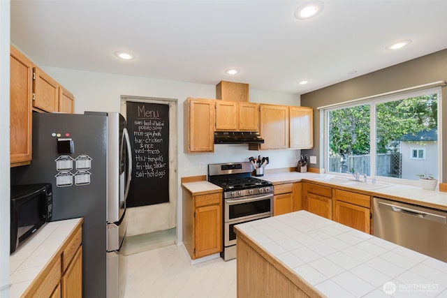 7315 E Collins Rd, Port Orchard, WA 98366 - kitchen with stainless steel appliances, under cabinet range hood, tile counters, and recessed lighting