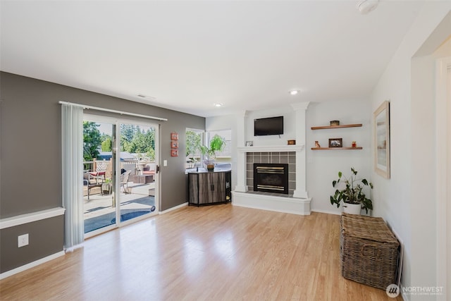7315 E Collins Rd, Port Orchard, WA 98366 - living room featuring light wood-type flooring, a tile fireplace, and recessed lighting