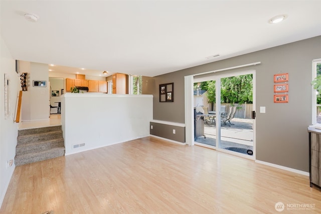7315 E Collins Rd, Port Orchard, WA 98366 - unfurnished living room with light wood-style floors, stairs, and recessed lighting