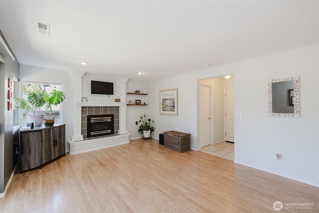 7315 E Collins Rd, Port Orchard, WA 98366 - unfurnished living room with light wood-style flooring, a fireplace, and recessed lighting