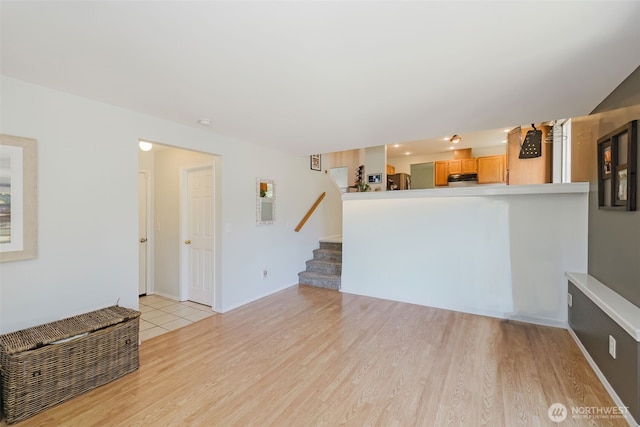 7315 E Collins Rd, Port Orchard, WA 98366 - unfurnished living room featuring stairway and light wood-style flooring