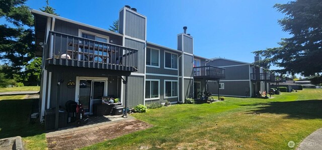 250 Charwila Ln, Enumclaw, WA 98022 - rear view of property featuring a balcony, a chimney, and a lawn