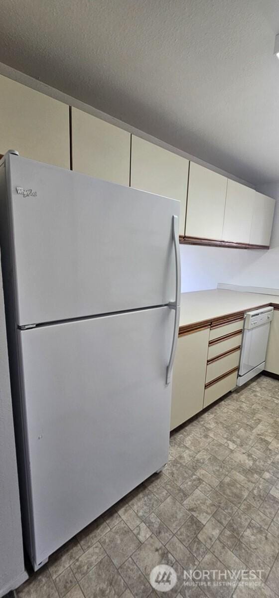 250 Charwila Ln, Enumclaw, WA 98022 - kitchen with white appliances, light countertops, a textured ceiling, and white cabinetry