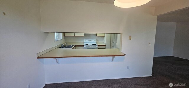 250 Charwila Ln, Enumclaw, WA 98022 - kitchen featuring white electric stove, dark carpet, a peninsula, and a kitchen bar