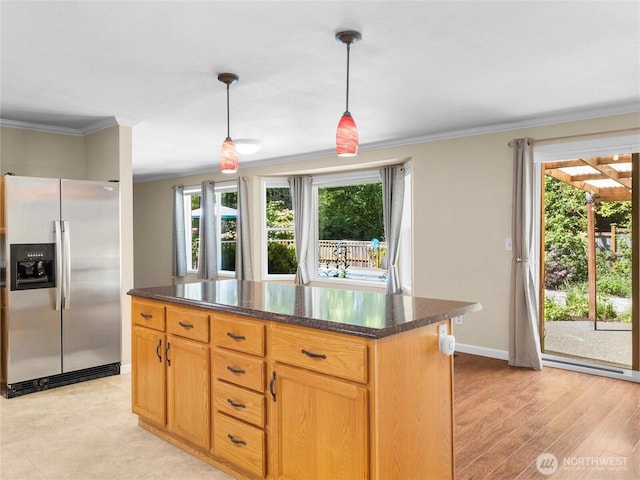 3929 Westpark Ct NW, Olympia, WA 98502 - kitchen with stainless steel fridge with ice dispenser, crown molding, plenty of natural light, decorative light fixtures, and a kitchen island
