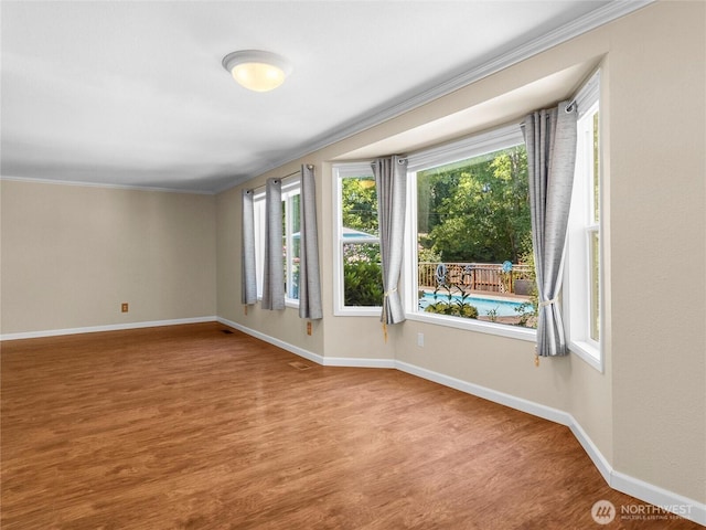 3929 Westpark Ct NW, Olympia, WA 98502 - empty room featuring wood finished floors and crown molding