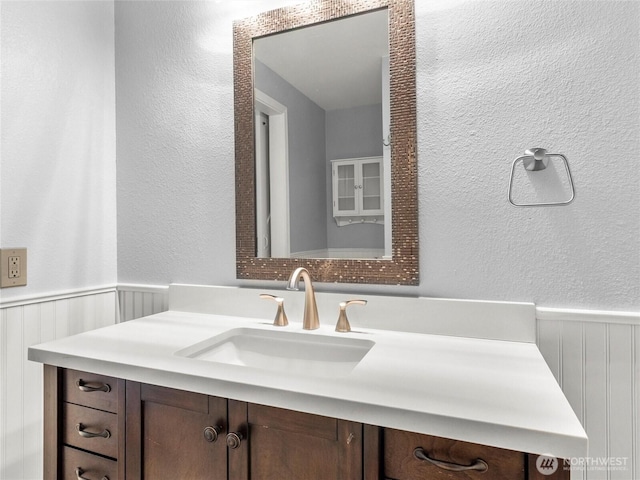 3929 Westpark Ct NW, Olympia, WA 98502 - bathroom with a wainscoted wall, a textured wall, and vanity