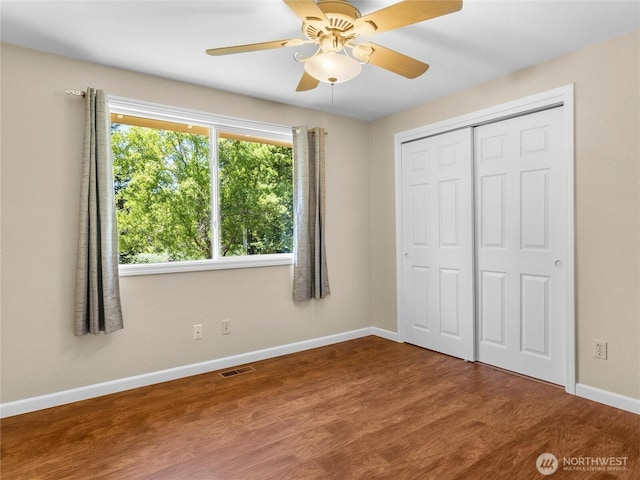 3929 Westpark Ct NW, Olympia, WA 98502 - unfurnished bedroom with wood finished floors, a closet, and ceiling fan