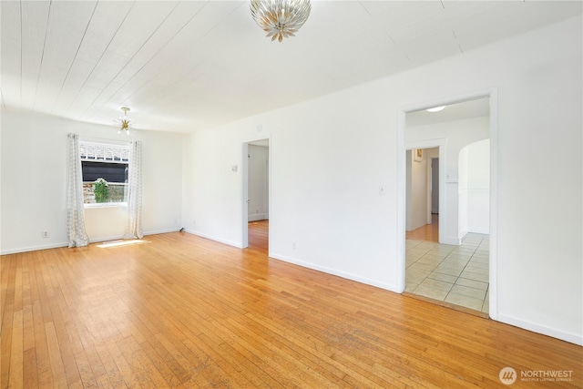 221 Thomas St N, Olympia, WA 98502 - spare room with light wood-type flooring, ceiling fan, and arched walkways