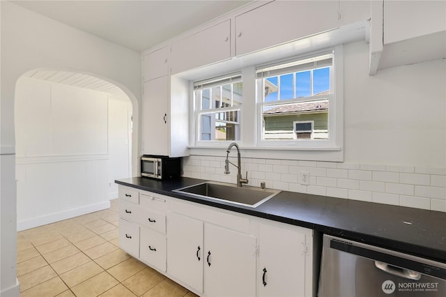 221 Thomas St N, Olympia, WA 98502 - kitchen with stainless steel appliances, dark countertops, decorative backsplash, and light tile patterned floors