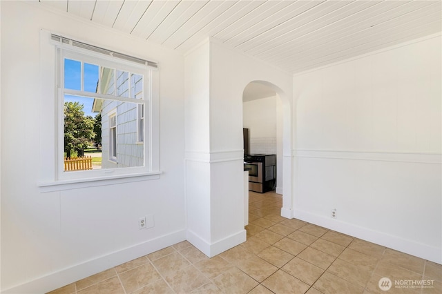 221 Thomas St N, Olympia, WA 98502 - empty room with light tile patterned flooring, arched walkways, and wood ceiling