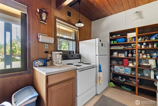324 Mizzen Ave NW, Ocean Shores, WA 98569 - kitchen featuring white appliances, wooden walls, light countertops, wooden ceiling, and hanging light fixtures