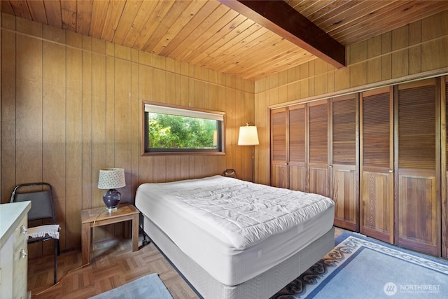 324 Mizzen Ave NW, Ocean Shores, WA 98569 - bedroom featuring a wooden ceiling with exposed beams, wooden walls, and a closet