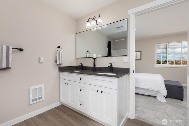 314 4th Ave S, Algona, WA 98001 - bathroom featuring double vanity and wood finished floors