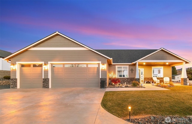 821 S Mary Ave, East Wenatchee, WA 98802 - view of front of property featuring a garage, stone siding, concrete driveway, and a front lawn