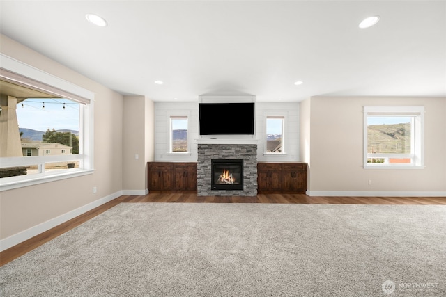 821 S Mary Ave, East Wenatchee, WA 98802 - unfurnished living room with healthy amount of natural light, a stone fireplace, wood finished floors, and recessed lighting