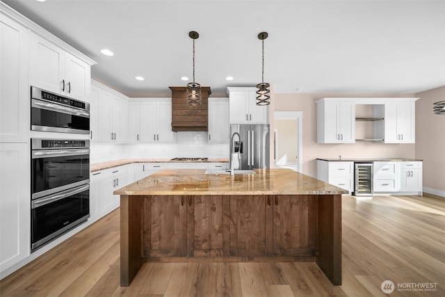 821 S Mary Ave, East Wenatchee, WA 98802 - kitchen featuring stainless steel appliances, open shelves, recessed lighting, light wood-style flooring, and backsplash