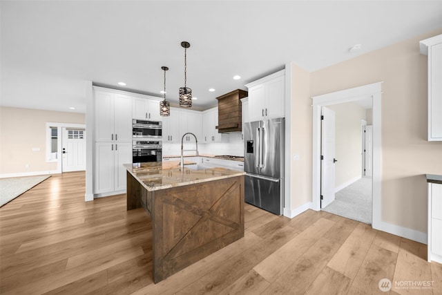 821 S Mary Ave, East Wenatchee, WA 98802 - kitchen featuring appliances with stainless steel finishes, light wood-type flooring, recessed lighting, light stone countertops, and white cabinets