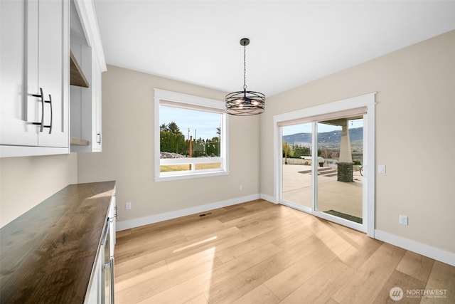 821 S Mary Ave, East Wenatchee, WA 98802 - unfurnished dining area with a chandelier and light wood-style flooring