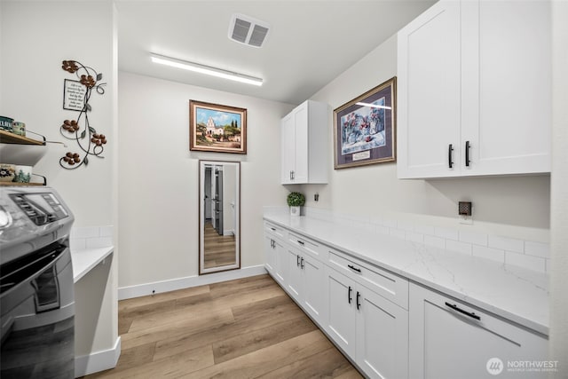 821 S Mary Ave, East Wenatchee, WA 98802 - kitchen with light wood finished floors, white cabinetry, light stone countertops, and open shelves