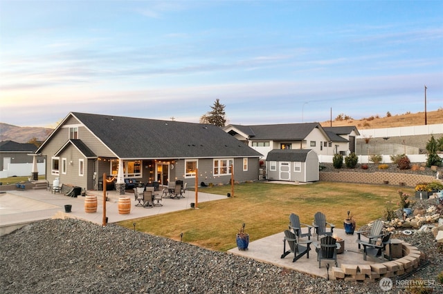 821 S Mary Ave, East Wenatchee, WA 98802 - back of house with an outdoor fire pit, a patio, a shed, and a lawn