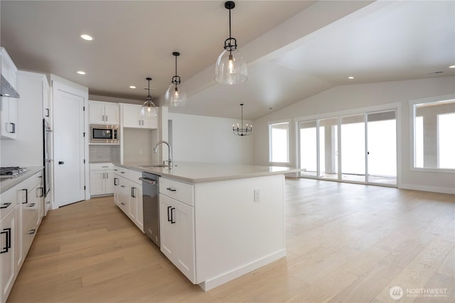 11413 Interlaaken Dr SW, Lakewood, WA 98498 - kitchen with stainless steel appliances, healthy amount of natural light, backsplash, light wood-style flooring, and lofted ceiling