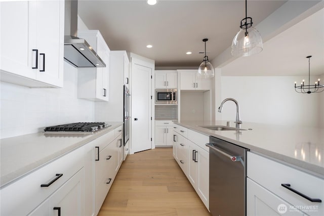 11413 Interlaaken Dr SW, Lakewood, WA 98498 - kitchen with appliances with stainless steel finishes, wall chimney exhaust hood, recessed lighting, light countertops, and decorative backsplash