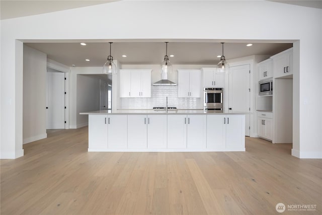 11413 Interlaaken Dr SW, Lakewood, WA 98498 - kitchen with appliances with stainless steel finishes, wall chimney exhaust hood, white cabinets, and recessed lighting