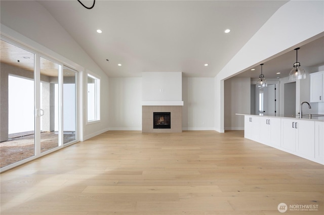11413 Interlaaken Dr SW, Lakewood, WA 98498 - unfurnished living room with vaulted ceiling, light wood finished floors, recessed lighting, and a fireplace