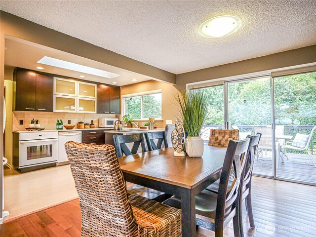 1709 NW 99th St, Seattle, WA 98117 - dining room featuring light wood-style floors and a textured ceiling