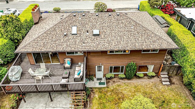 1709 NW 99th St, Seattle, WA 98117 - back of property featuring a shingled roof, a wooden deck, and a chimney