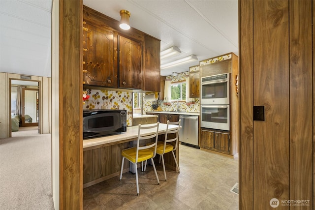 1171 E Trails End Dr, Belfair, WA 98528 - kitchen with appliances with stainless steel finishes, built in desk, and light countertops