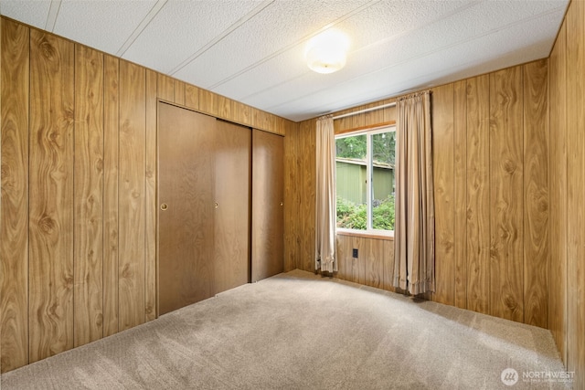 1171 E Trails End Dr, Belfair, WA 98528 - spare room featuring carpet flooring and wood walls